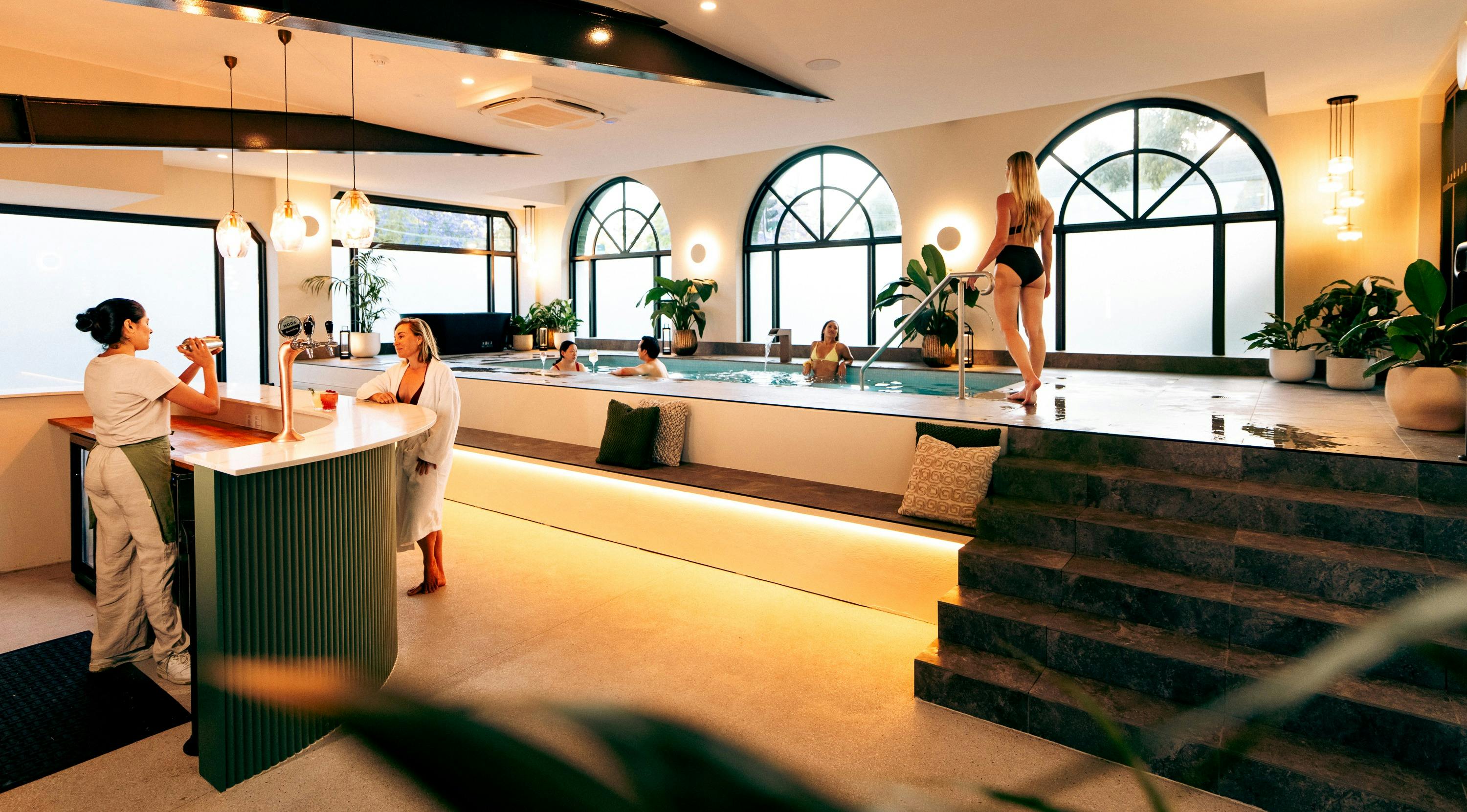 A beautiful shared wellness space featuring a tranquil mineral pool, a cold ice bath, and the modern