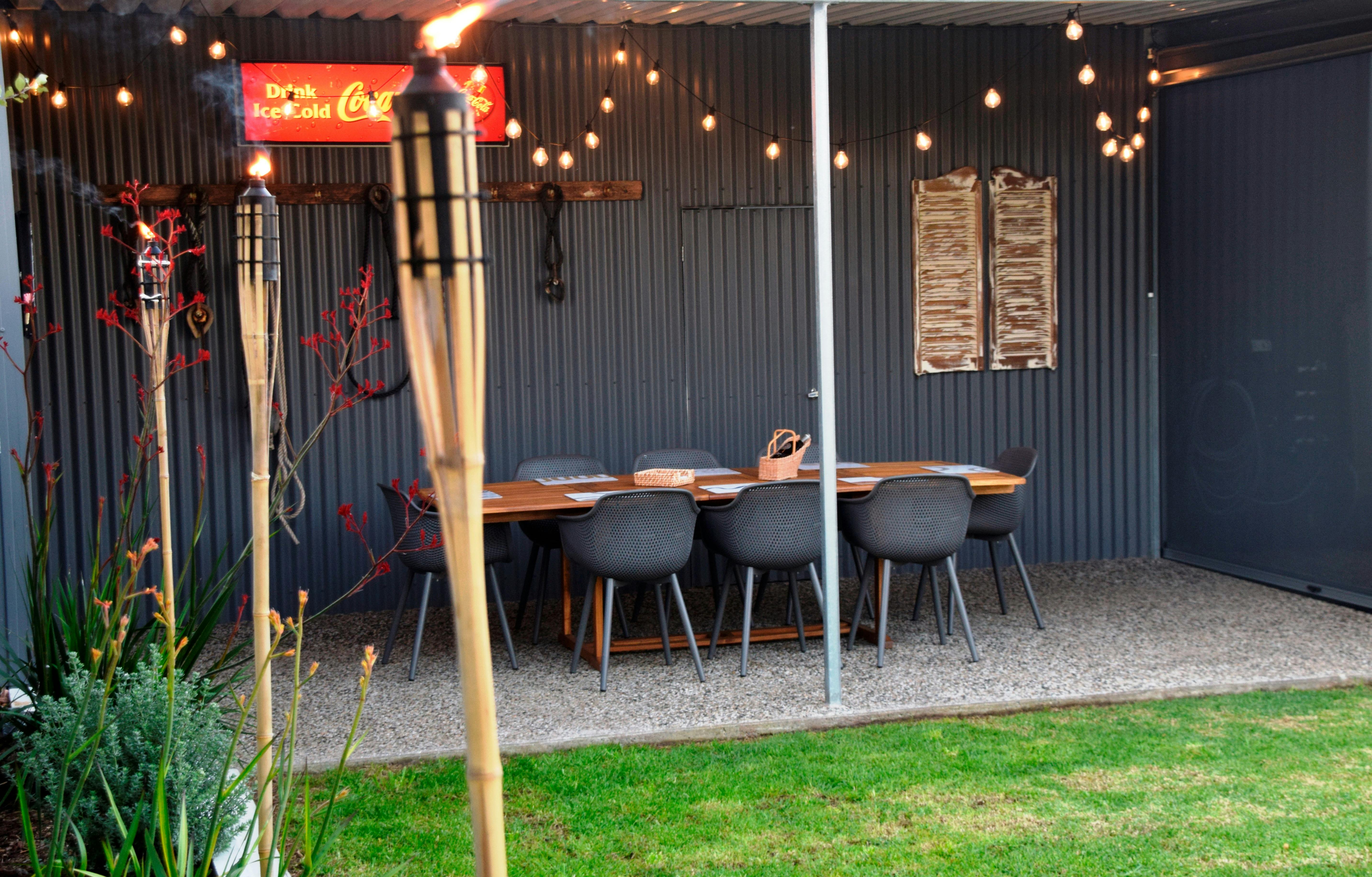 Games and dining area undercover and protected from the elements with  lovely green lawn