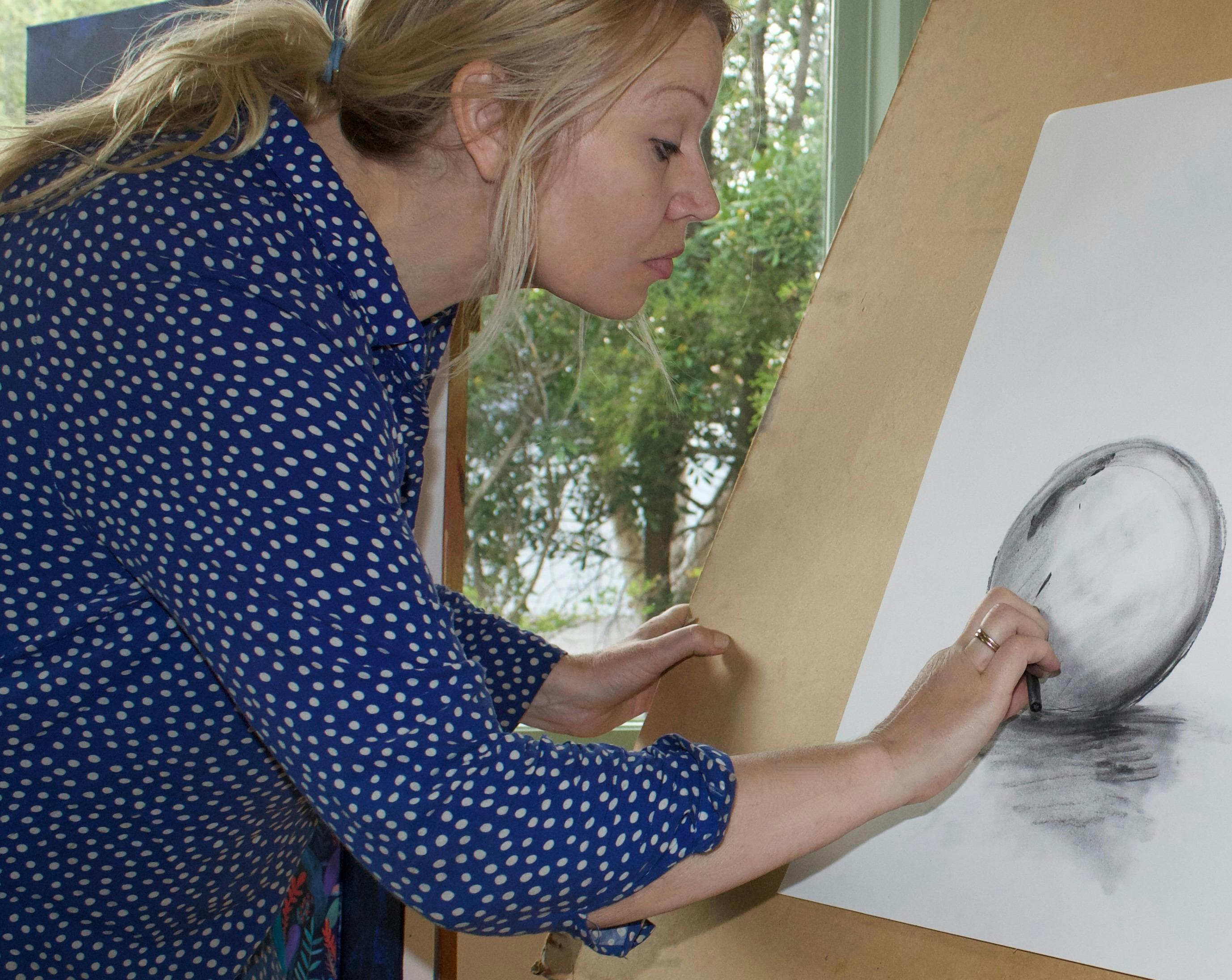 artist Mara Jordan sketching with charcoal