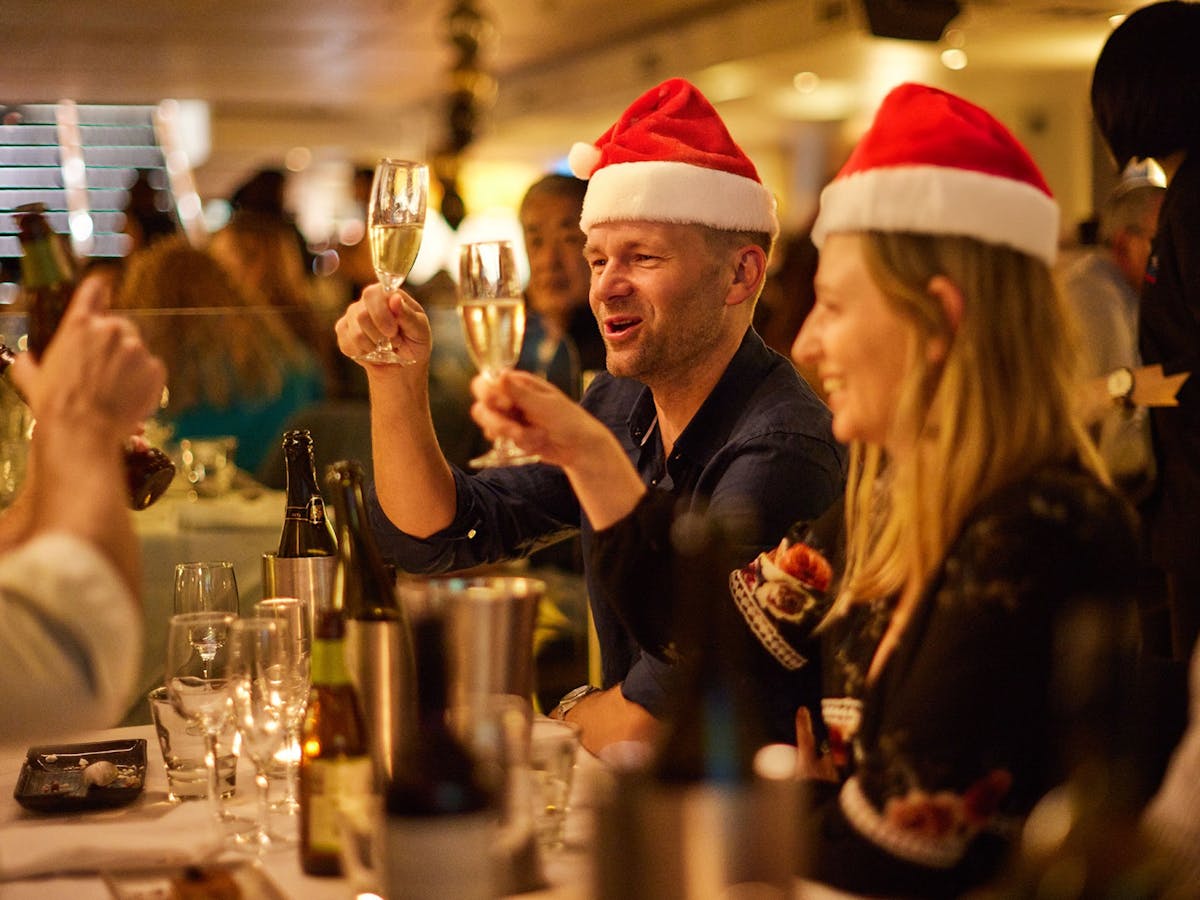 People celebrating on the Showboat Christmas party dinner cruise