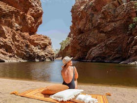 Woman relaxing on a sand bank at Ellery Creek