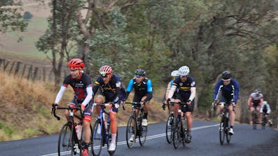 Group of riders ascending through scenic countryside