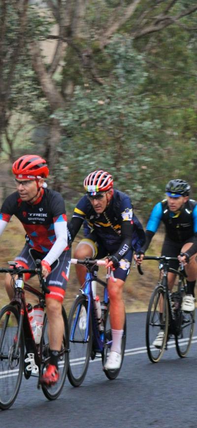 Group of riders ascending through scenic countryside