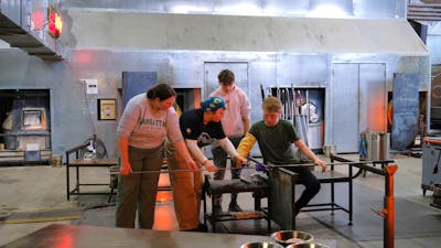 Participants and teacher during glassblowing class