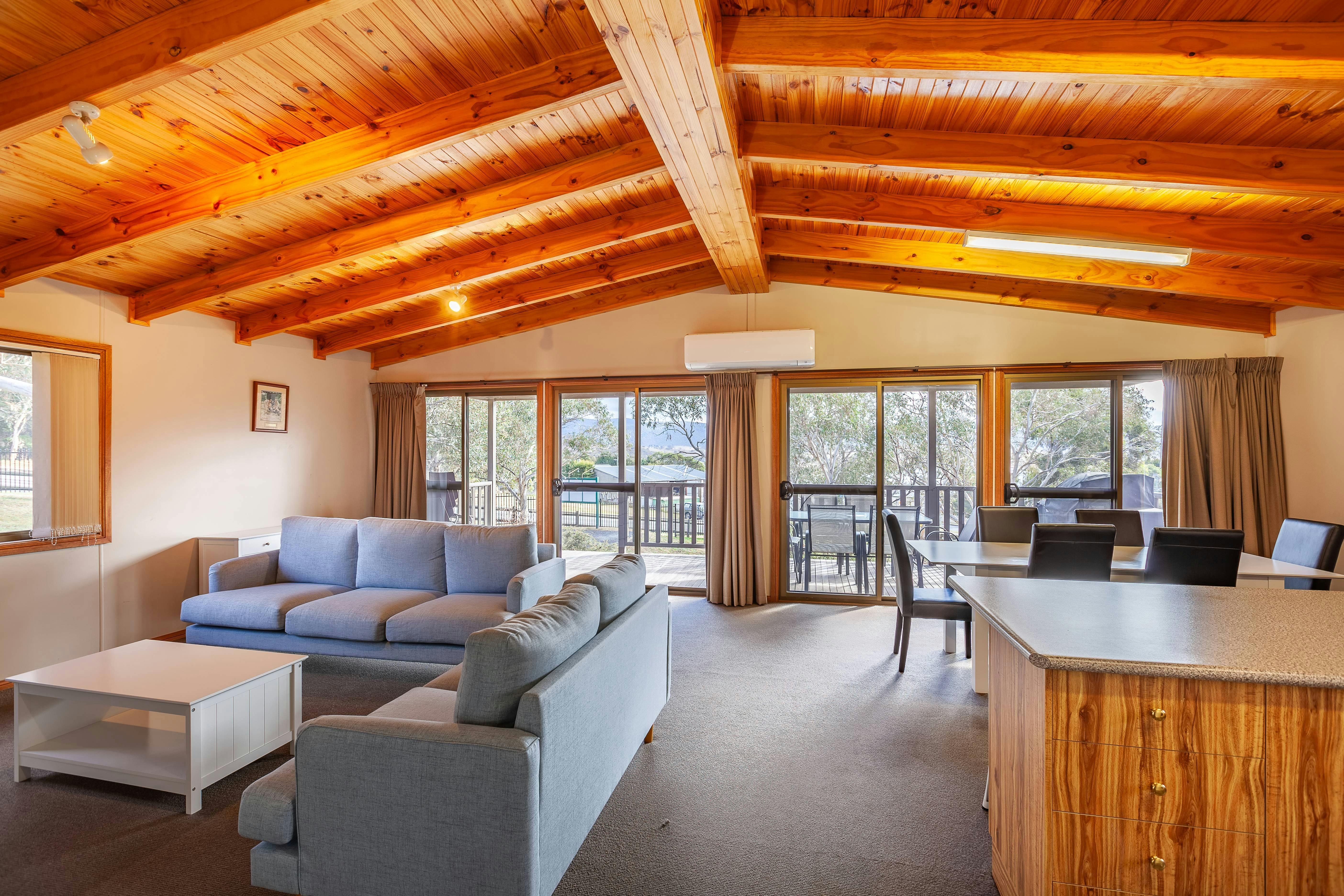 Lounge and dining area of cottage with view over balcony