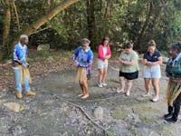 Visitors taking part in a Gunggandji cultural experience on Kumbrra