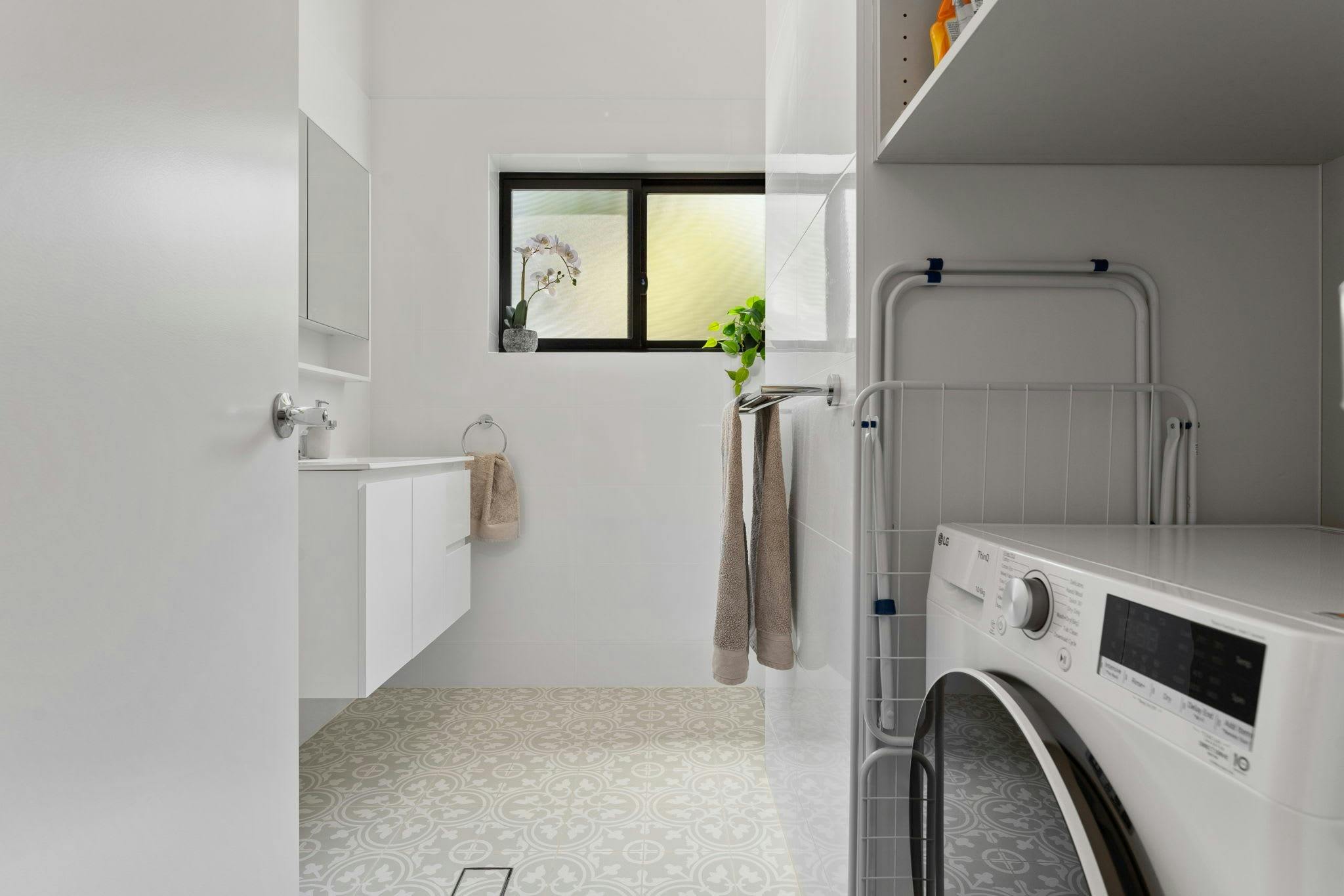 Washing Machine in nook of bathroom