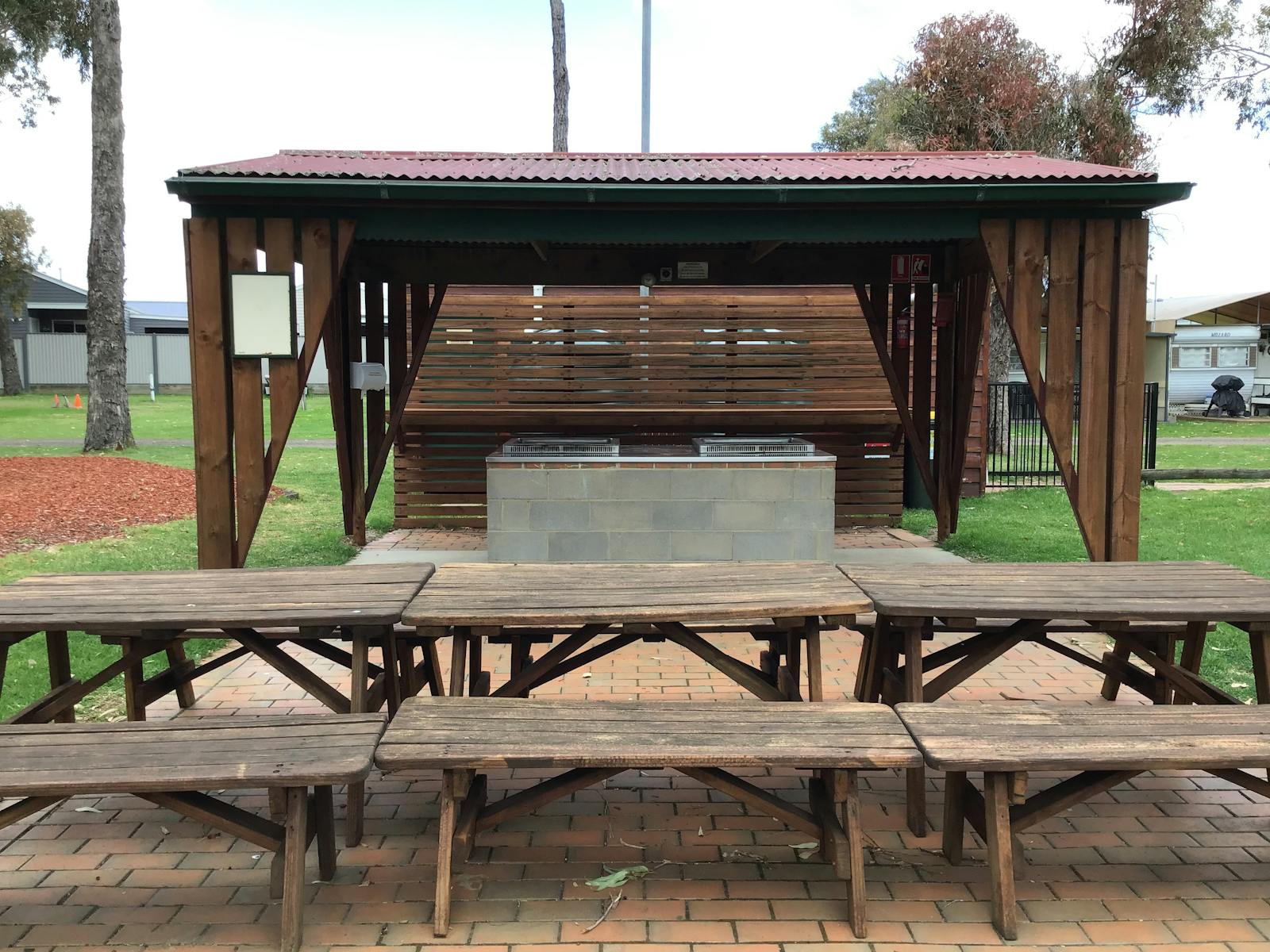 Covered BBQ area with tables and chairs