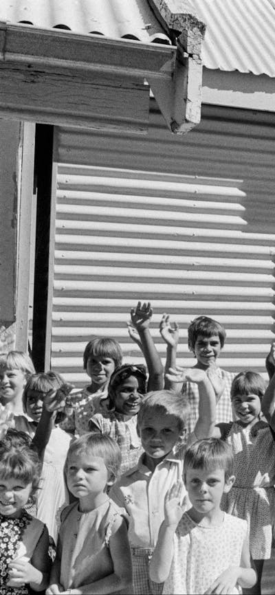 B&W photograph of children at Cook train station waving goodbye to a train