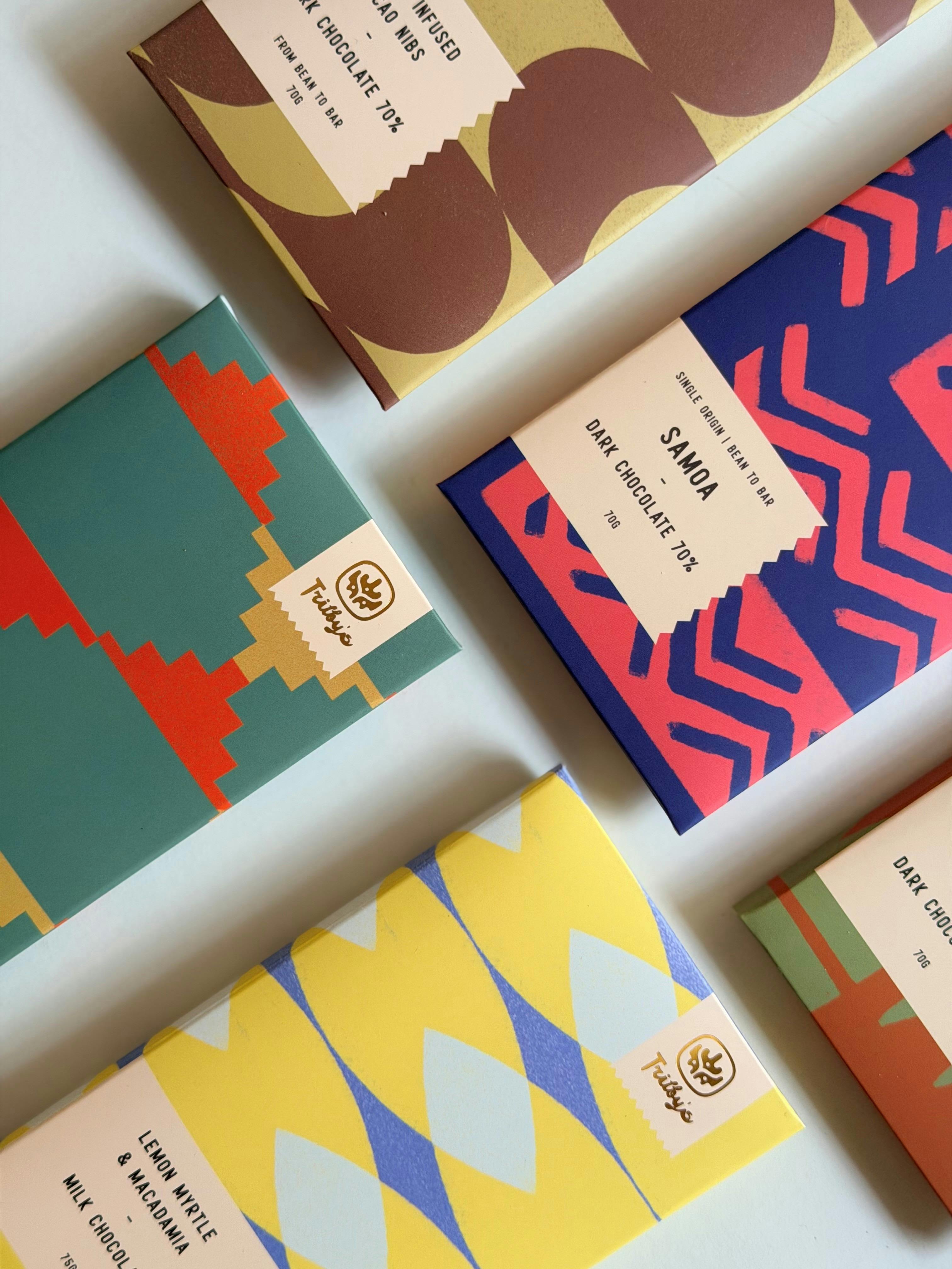Flat lay of Trilby’s colourful chocolate bars arranged on a light background.