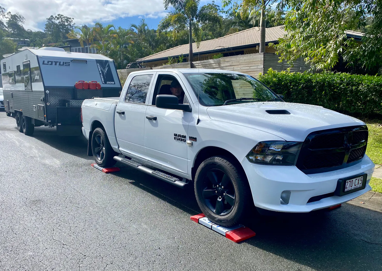 White Ute being weighed on scales while towing caravan