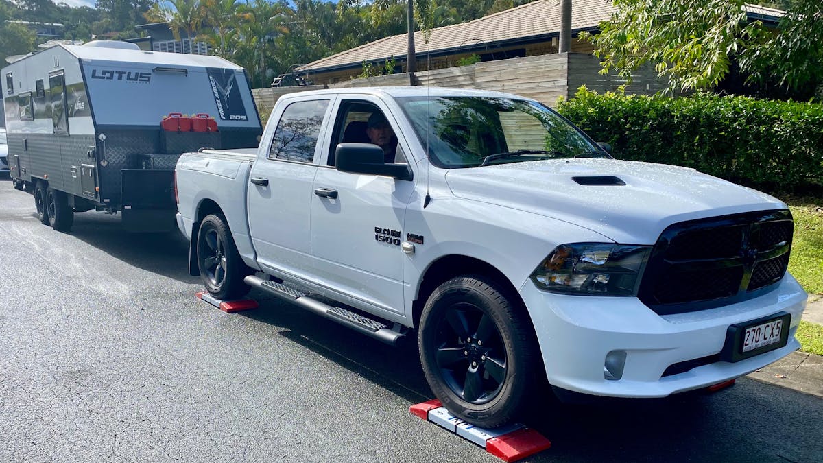 White Ute being weighed on scales while towing caravan