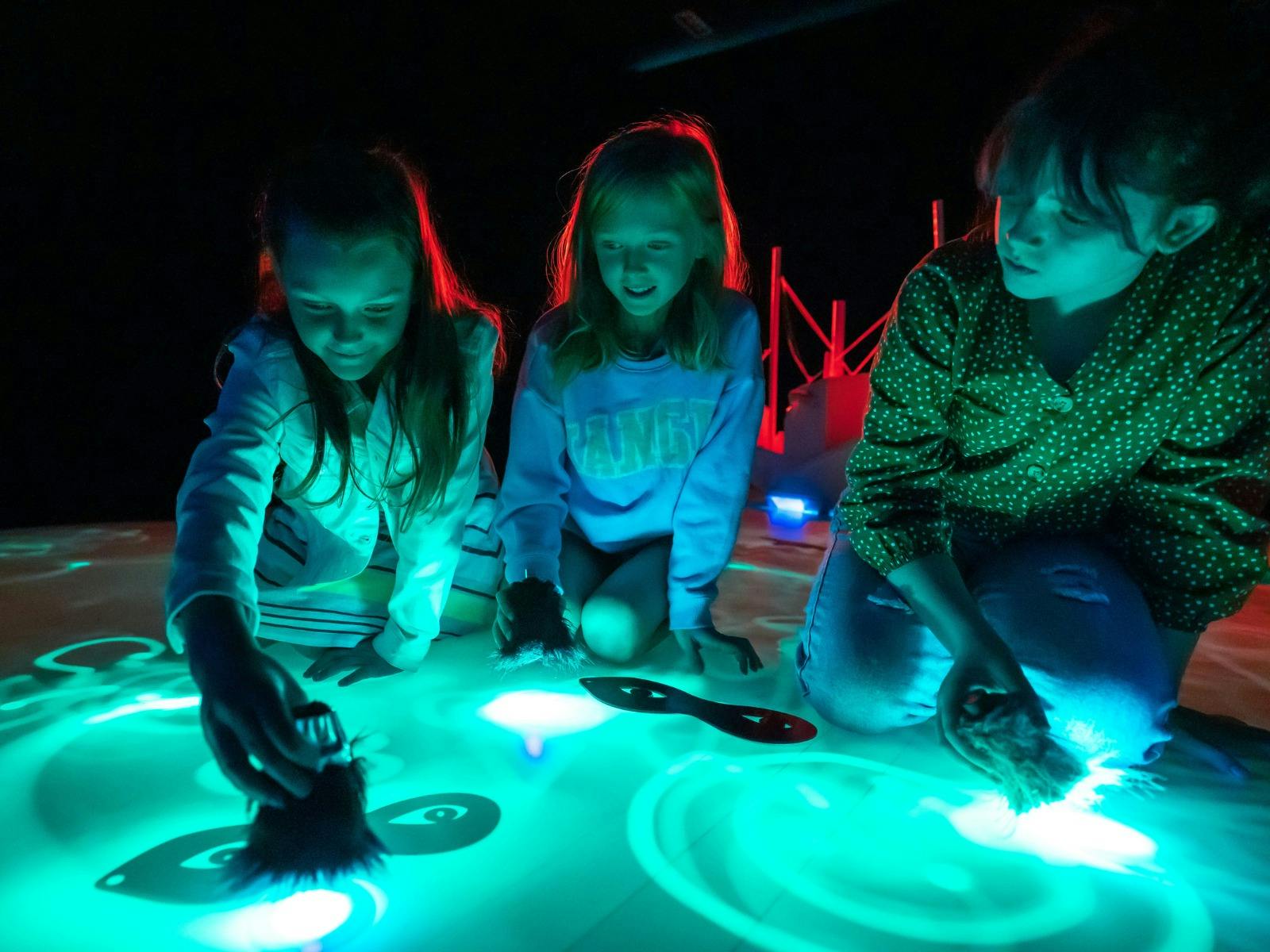 Young kids playing with light installations Young kids playing with light installations