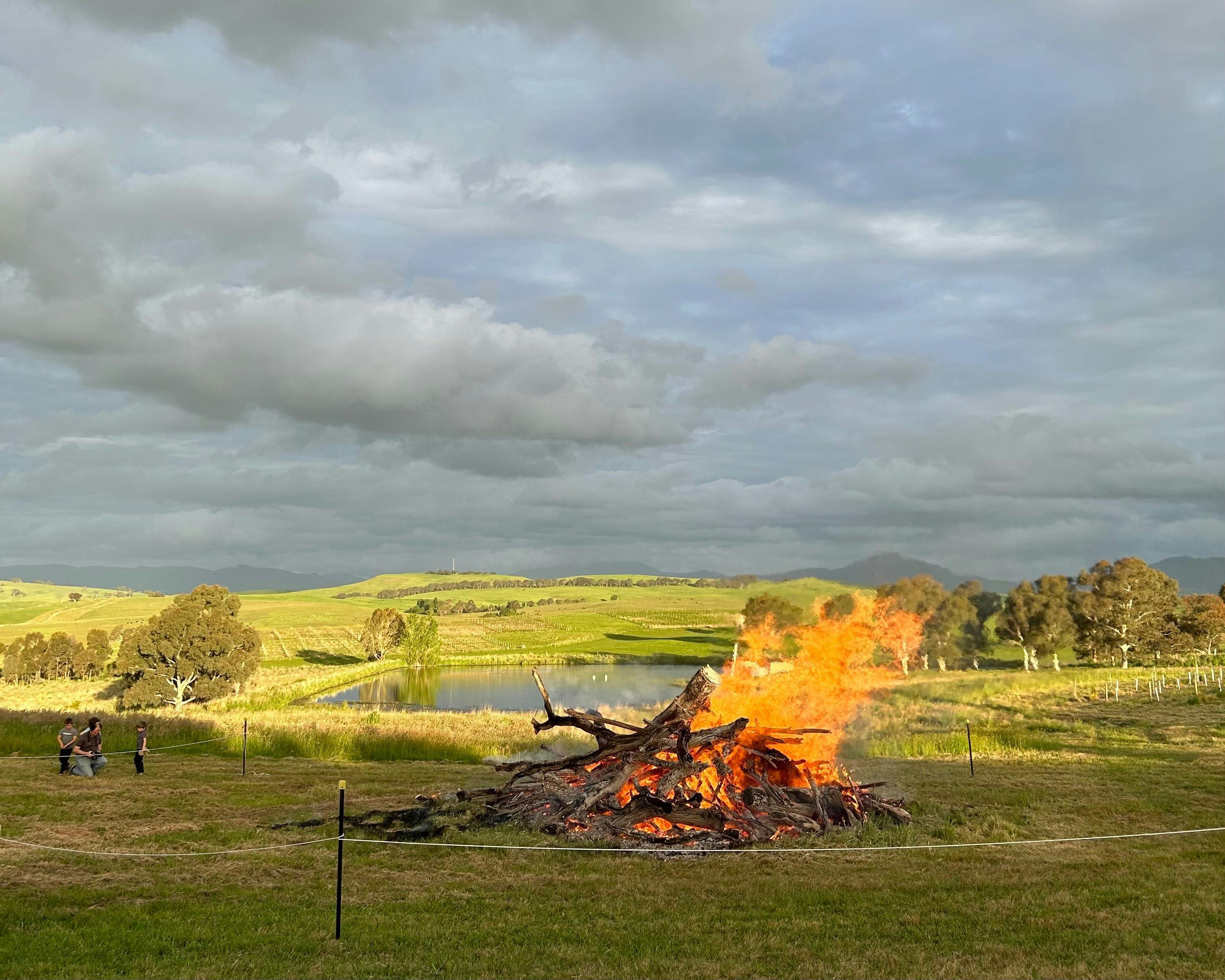 Bonfire with a rope around it and mountains behind it