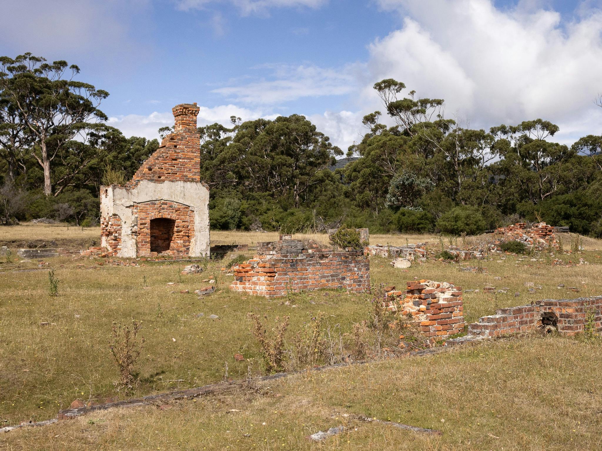 a natural landscape with ruins of historic buildings and structures