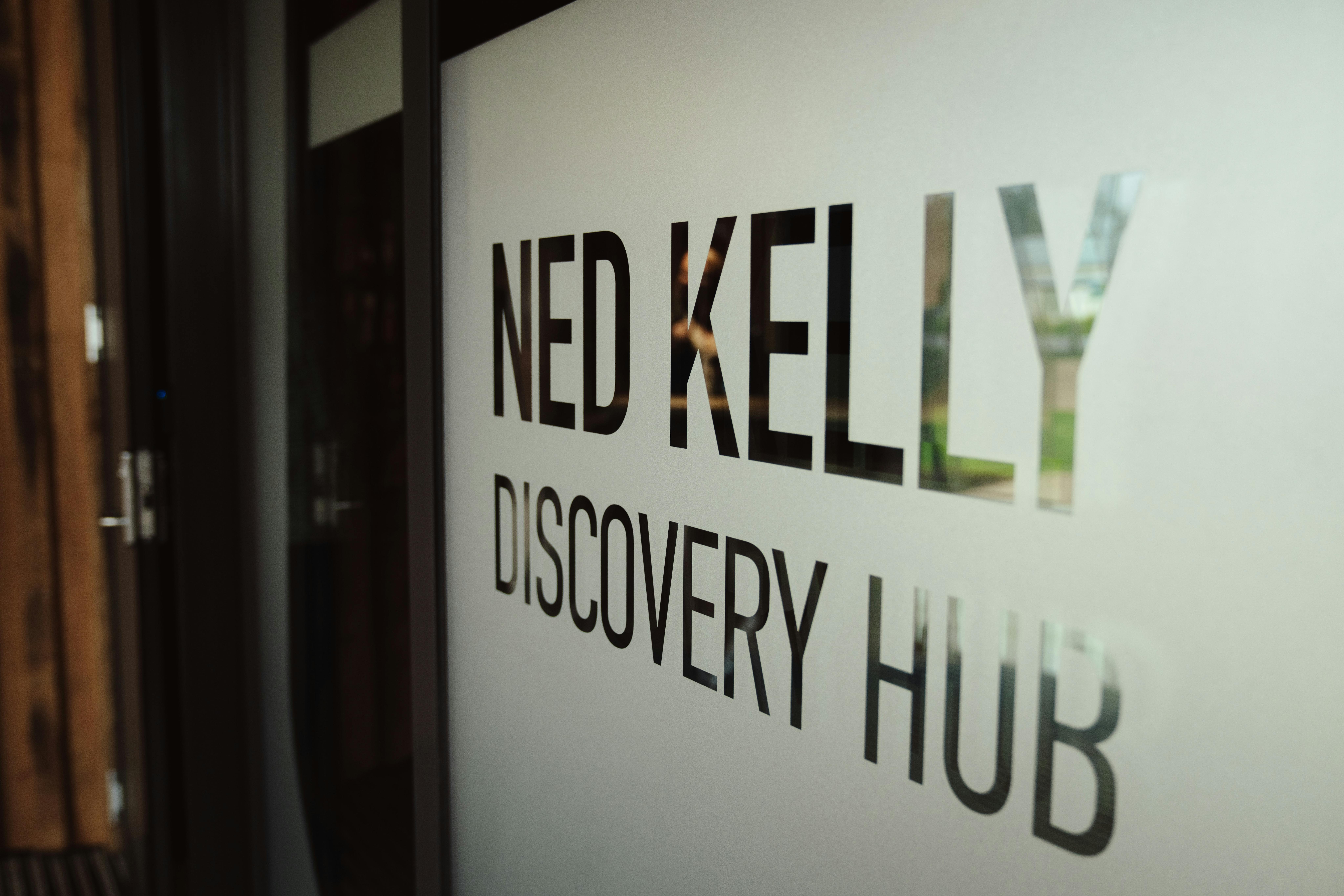 Frosted glass door with words Ned Kelly Discovery hub