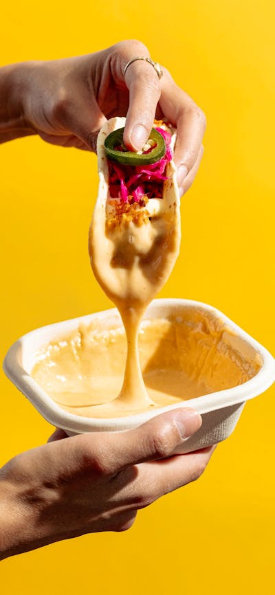 Tacos dipped in our house nachos cheese sauce