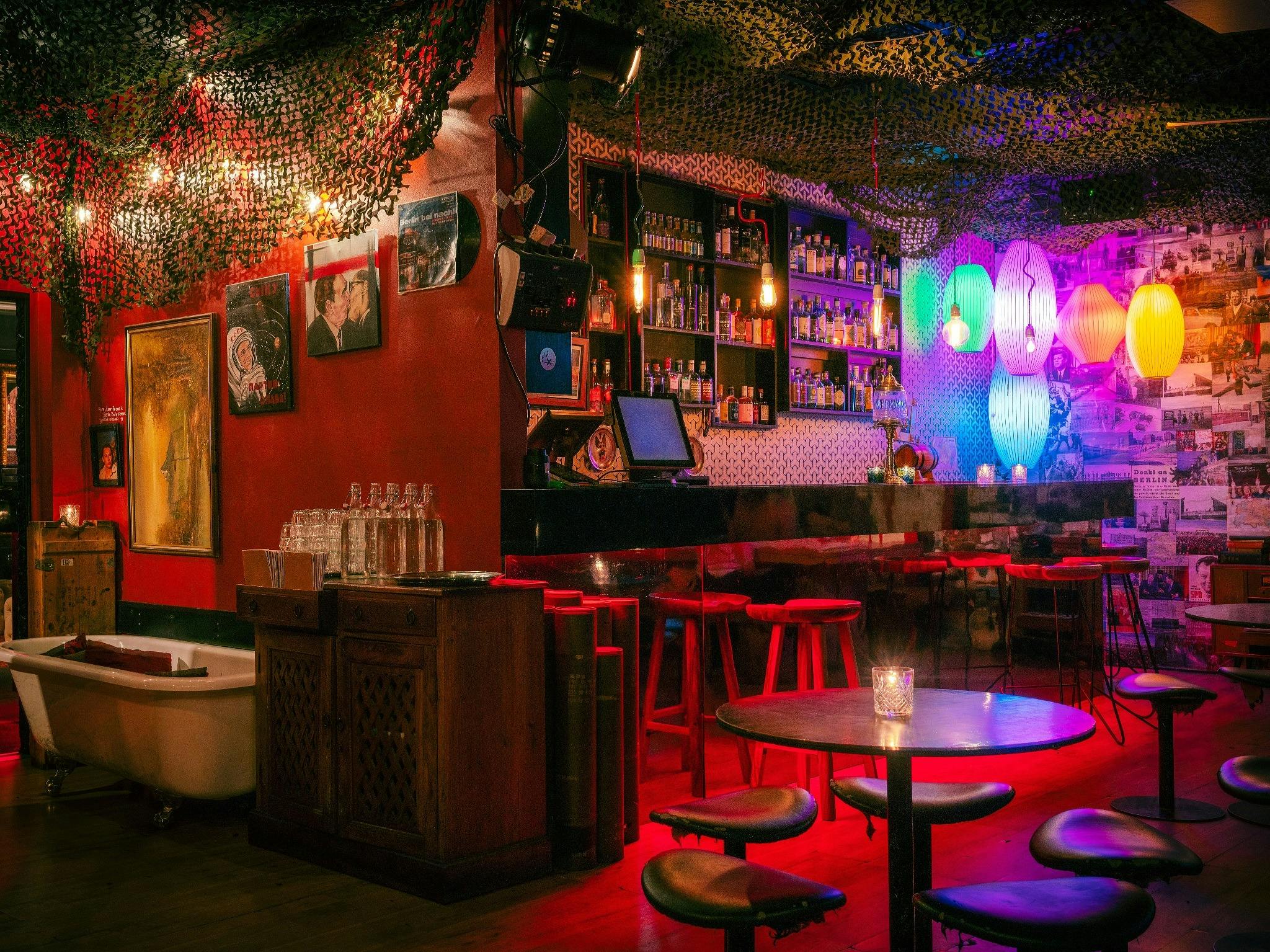 The interior of a hidden bar with colourful lights