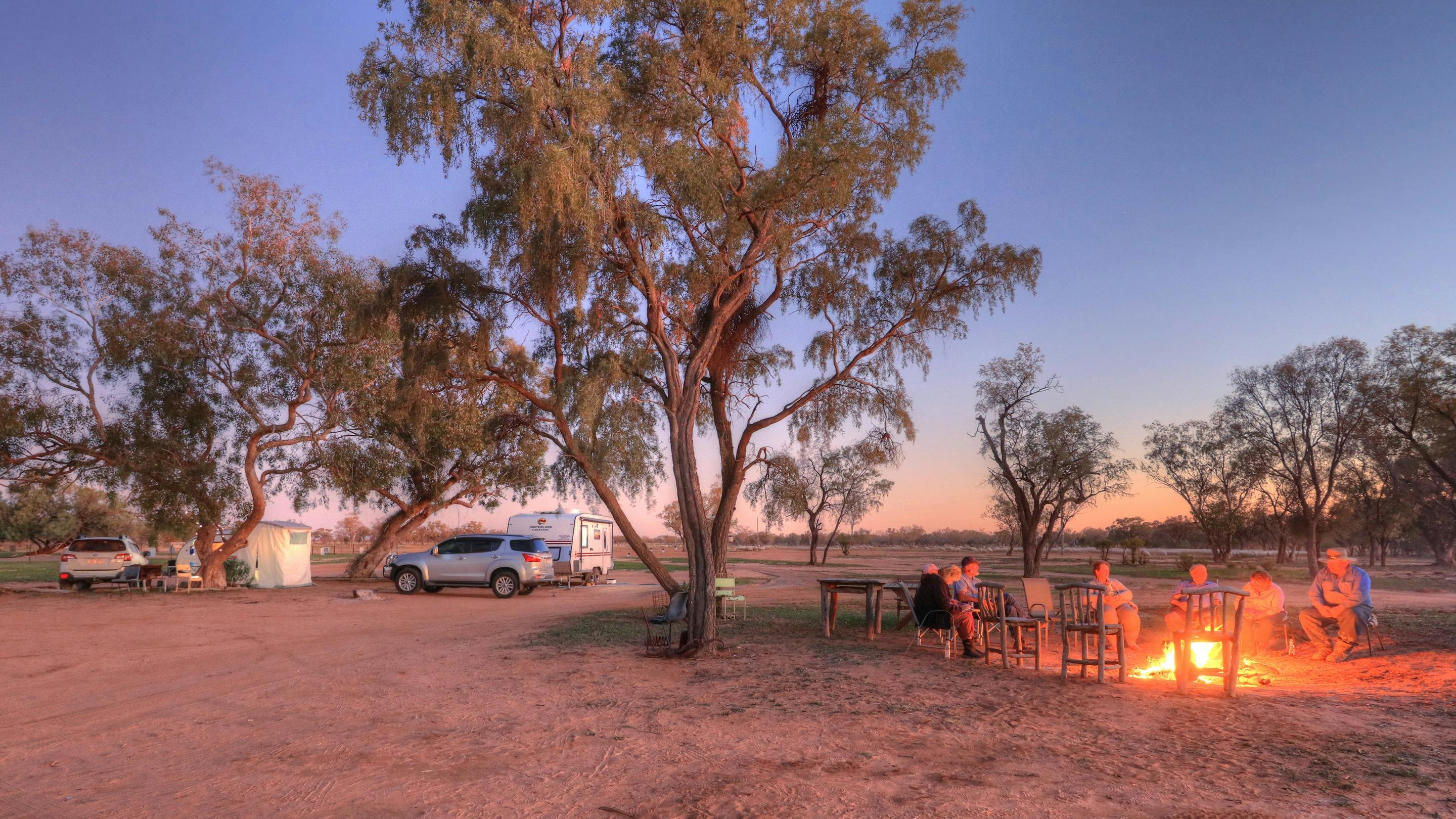 Campers sitting around a fire at the Shearer's Campsite at Charlotte Plains, Outback Queensland