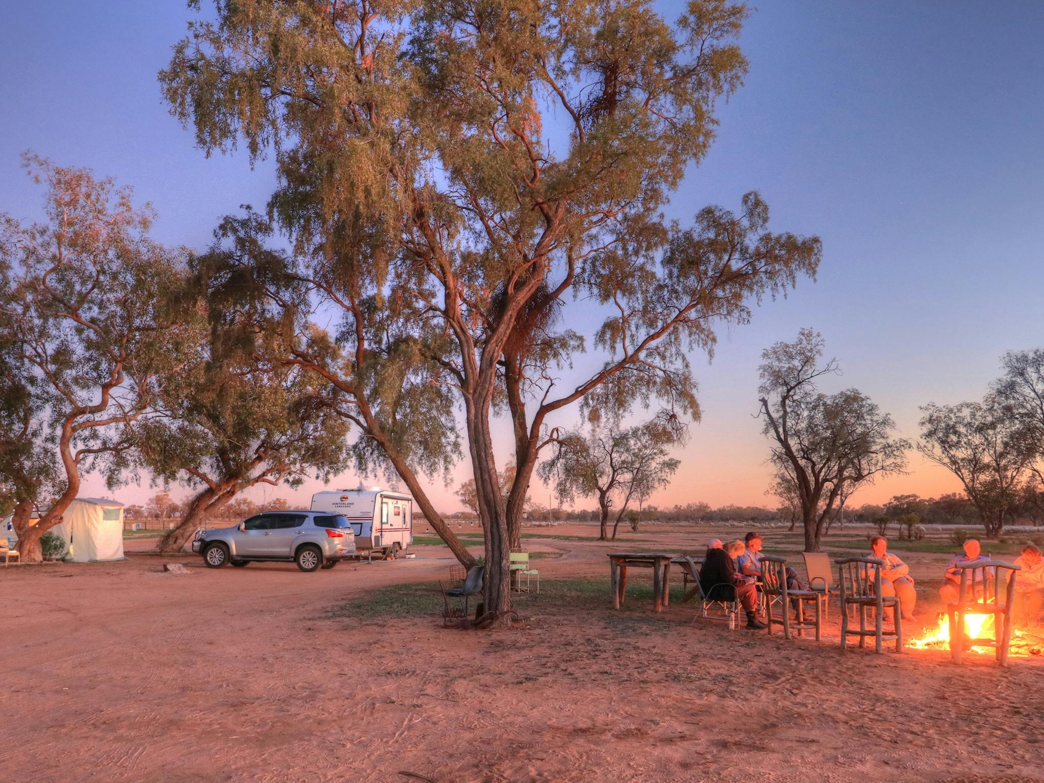 Campers sitting around a fire at the Shearer's Campsite at Charlotte Plains, Outback Queensland Campers sitting around a fire at the Shearer's Campsite at Charlotte Plains, Outback Queensland