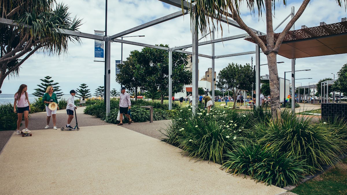 A family enjoying the glorious views of the Gladtsone Harbour whilst walking along the walkway