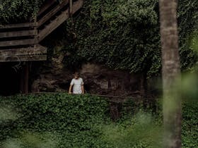 Person walking along the inside ledge of the sinkhole