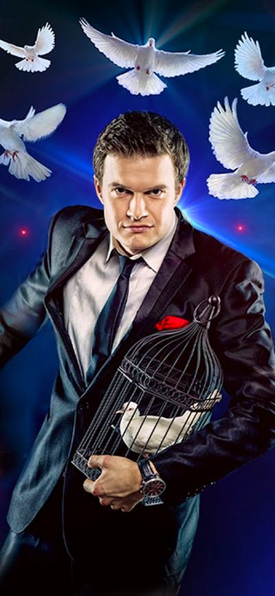 A man surrounded by doves and a bunny, against a blue background