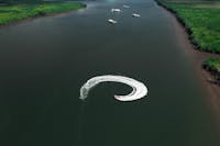 Drone shot of the Cairns Jet Boat Bad Fishy creating waves while spinning in Cairns