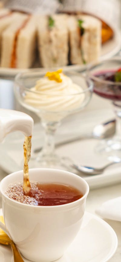 Pouring tea into cup