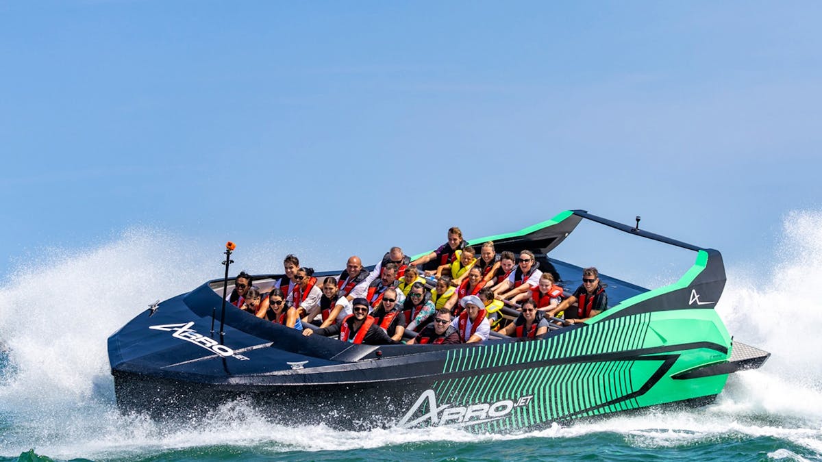 Guests on black and green Arro Jet Boat.