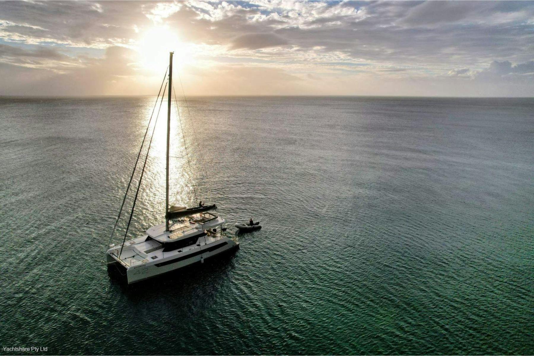 Catamaran with mast on calm sea