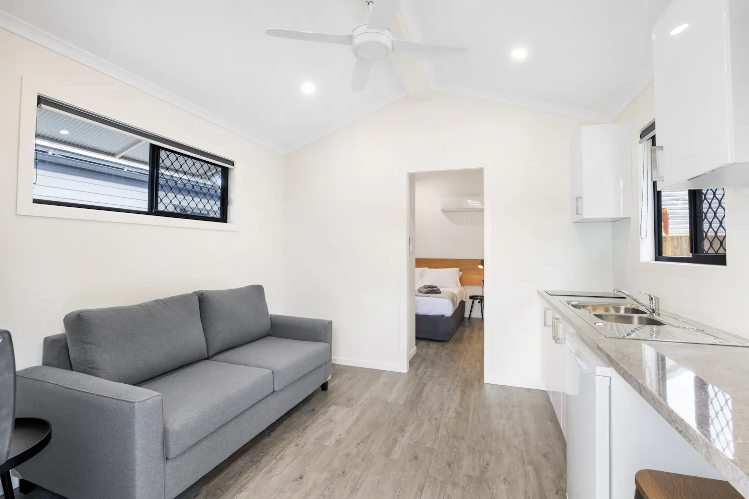 One Bedroom lounge room with kitchenette and tv.