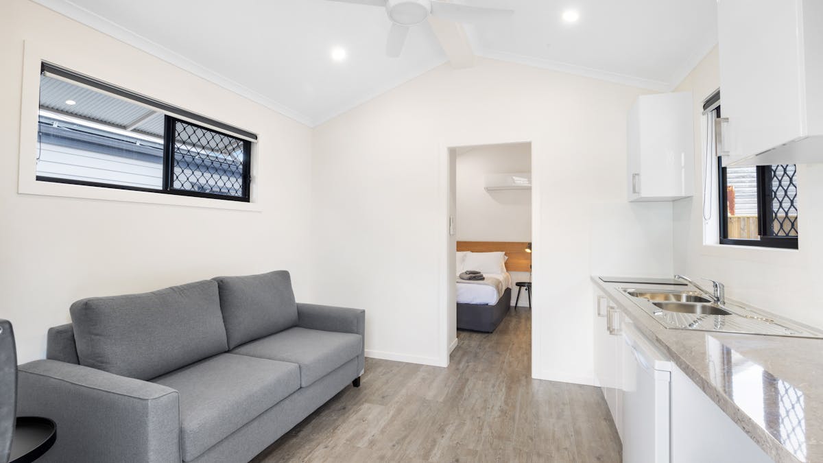 One Bedroom lounge room with kitchenette and tv.