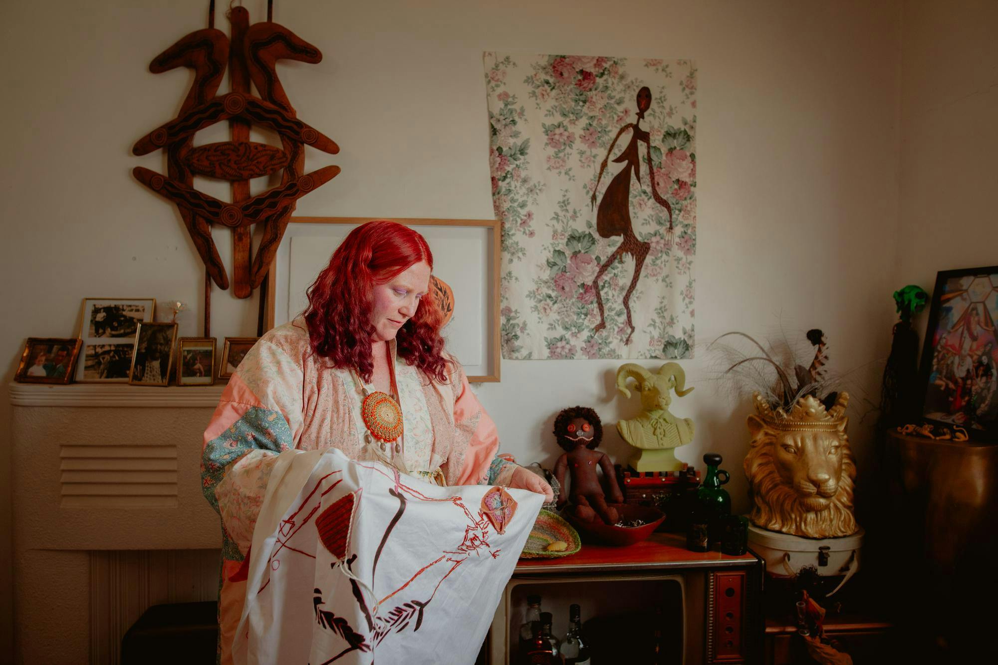 Photograph of tutor and artist Krystle Evans with her art work, taken by Em Jensen