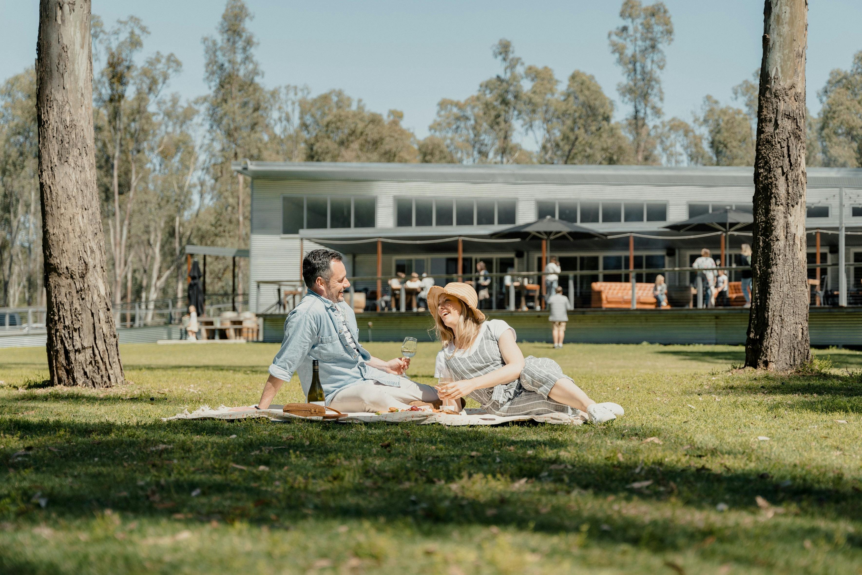 Couple enjoying a picnic at The Timbercutter in Mathoura