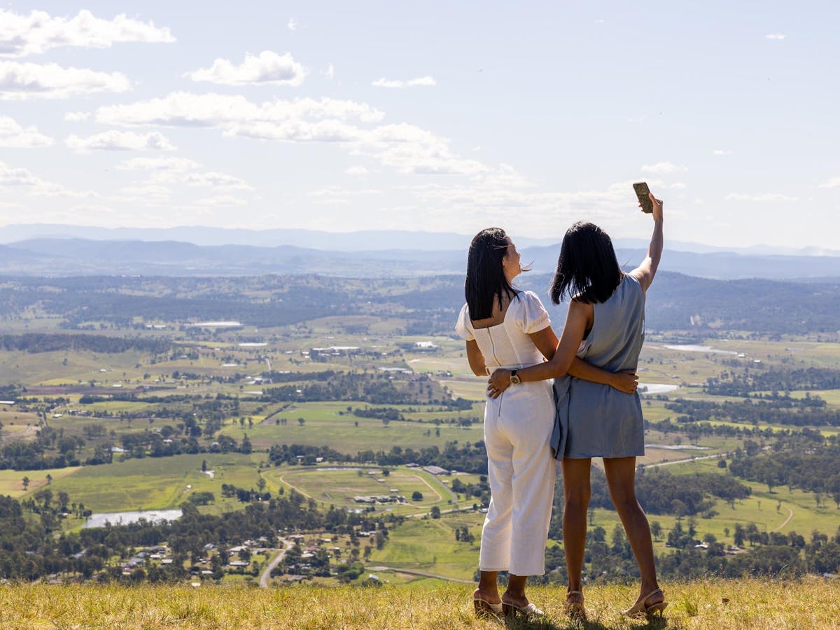 Two ladies taking photos at scenic lookout Two ladies taking photos at scenic lookout