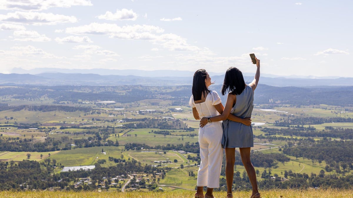 Two ladies taking photos at scenic lookout