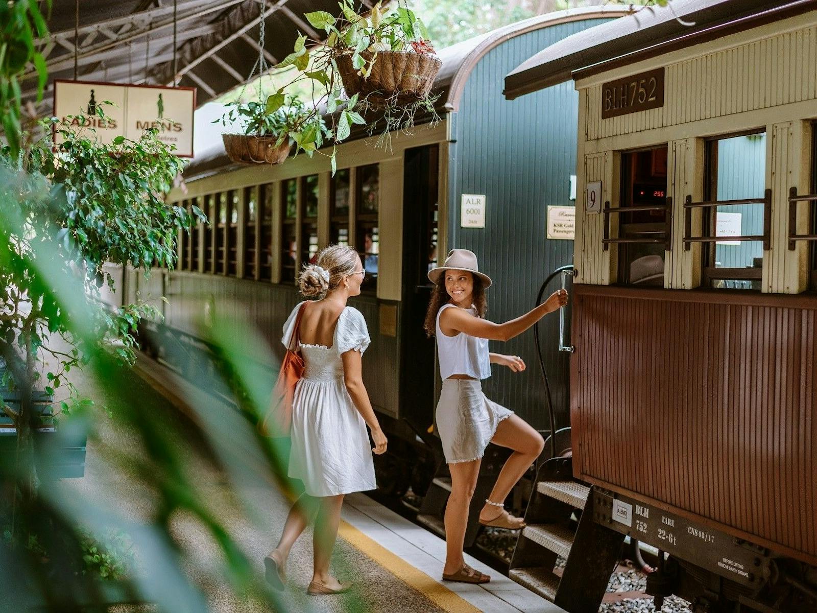 Two young smiling women about to board a Heritage Carriage of the Kuranda Scenic Rail Two young smiling women about to board a Heritage Carriage of the Kuranda Scenic Rail