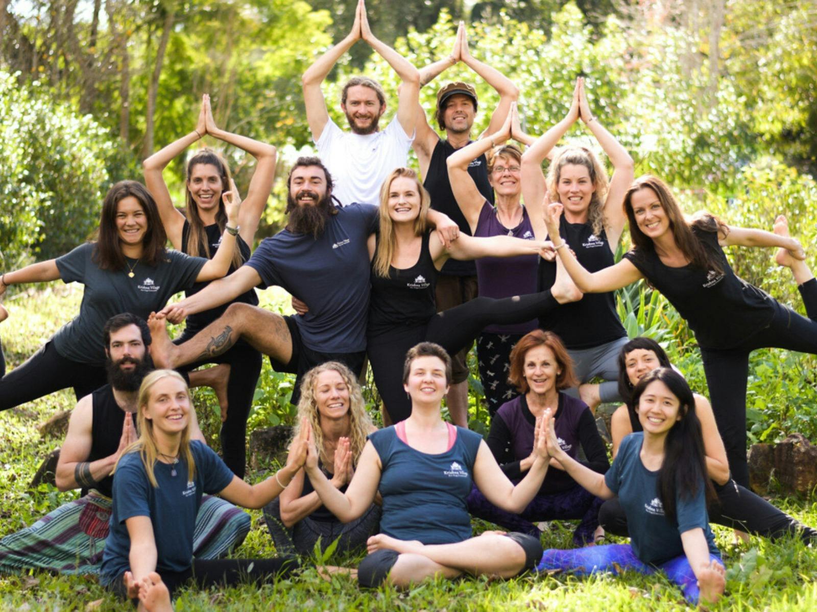 A group of about 15 yogis of all ages and nationalities, posing for a group photo