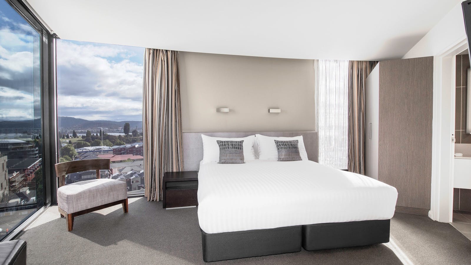 One Bedroom Apartment has a King size bed, floor to ceiling windows, private bedroom with TV.