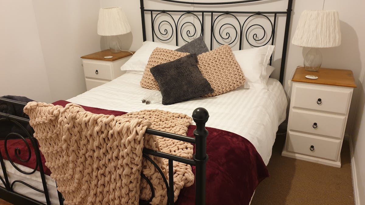 Brass framed bed with luxurious linens and soft blankets Brass framed bed with luxurious linens and soft blankets