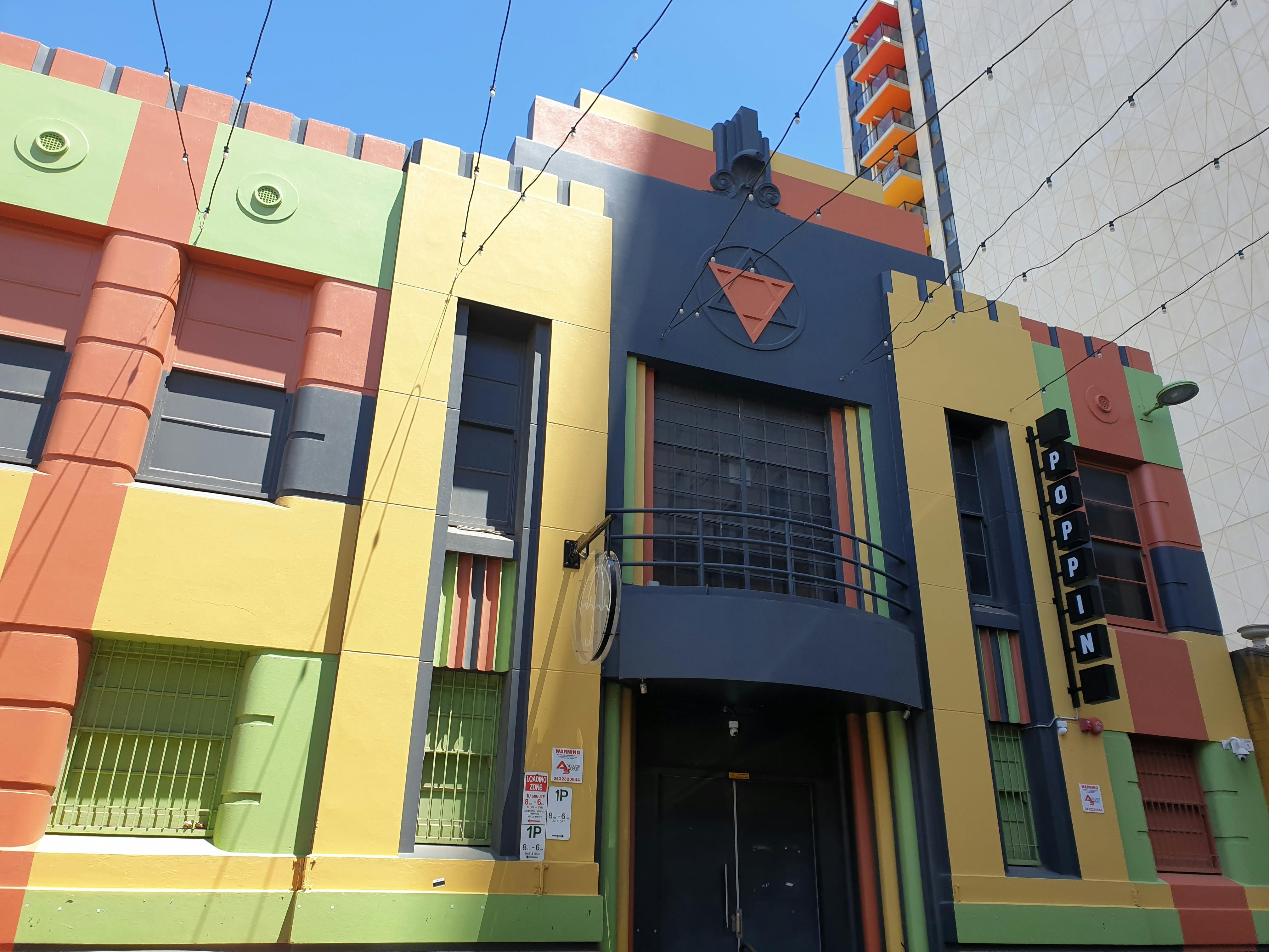 The entrance of Adelaide queer nightclub Mary's Poppin, painted in various bright colours.