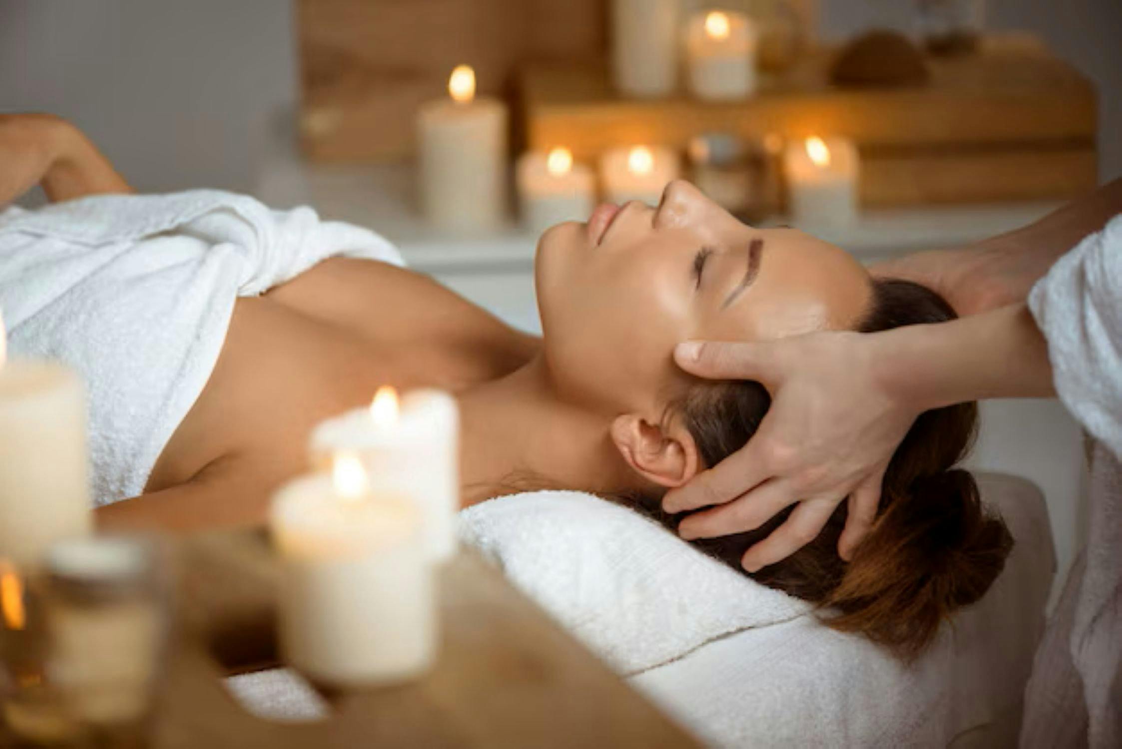 Candles, lady laying down, spa treatment