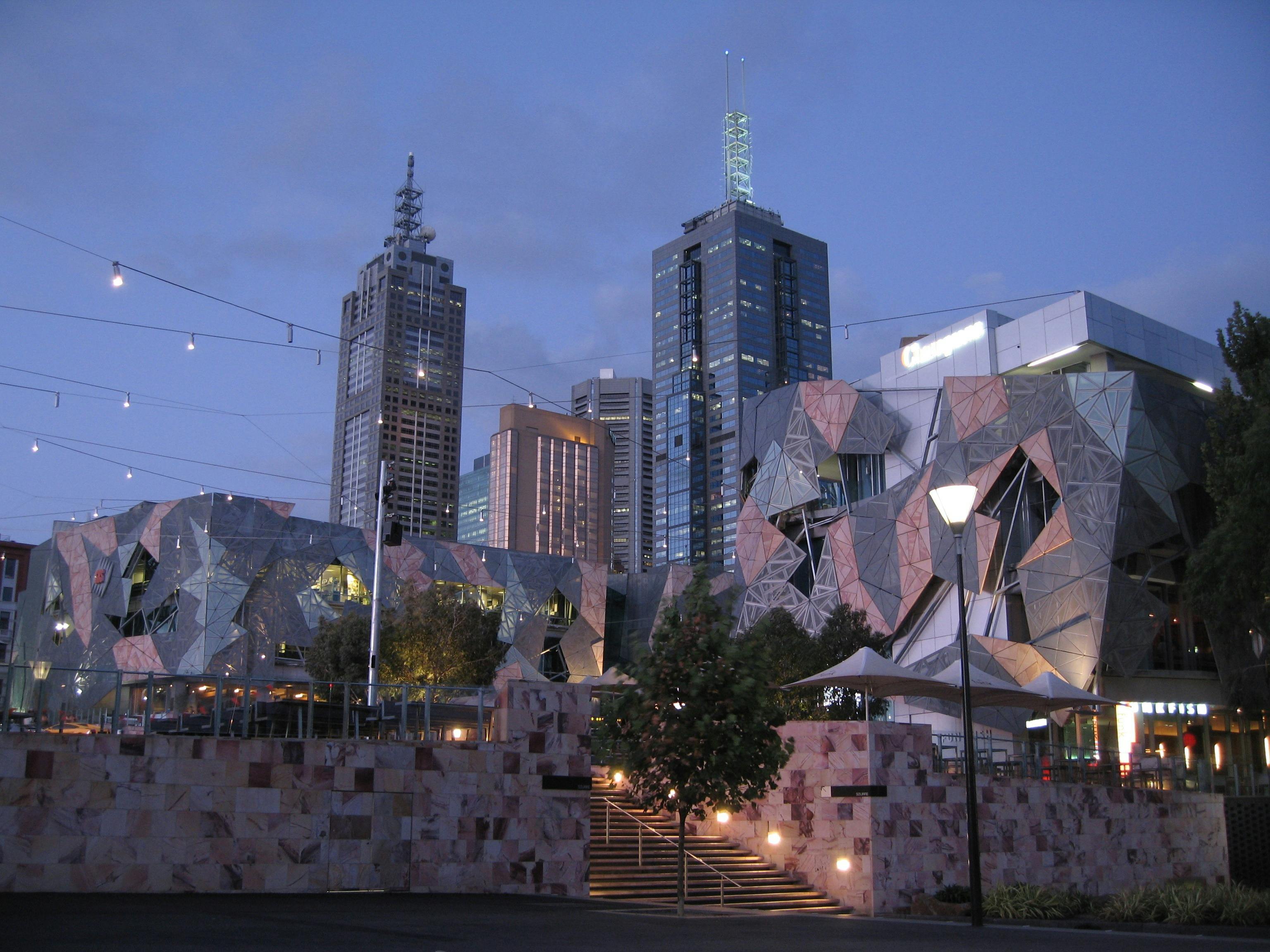 Federation Square at dusk with city skyline in background