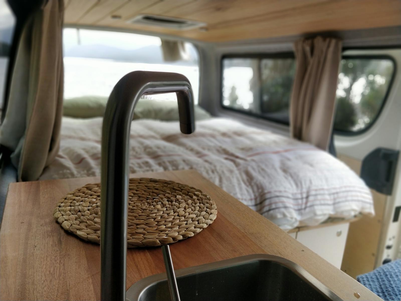 comfy campervan hire with water, electricity and bed