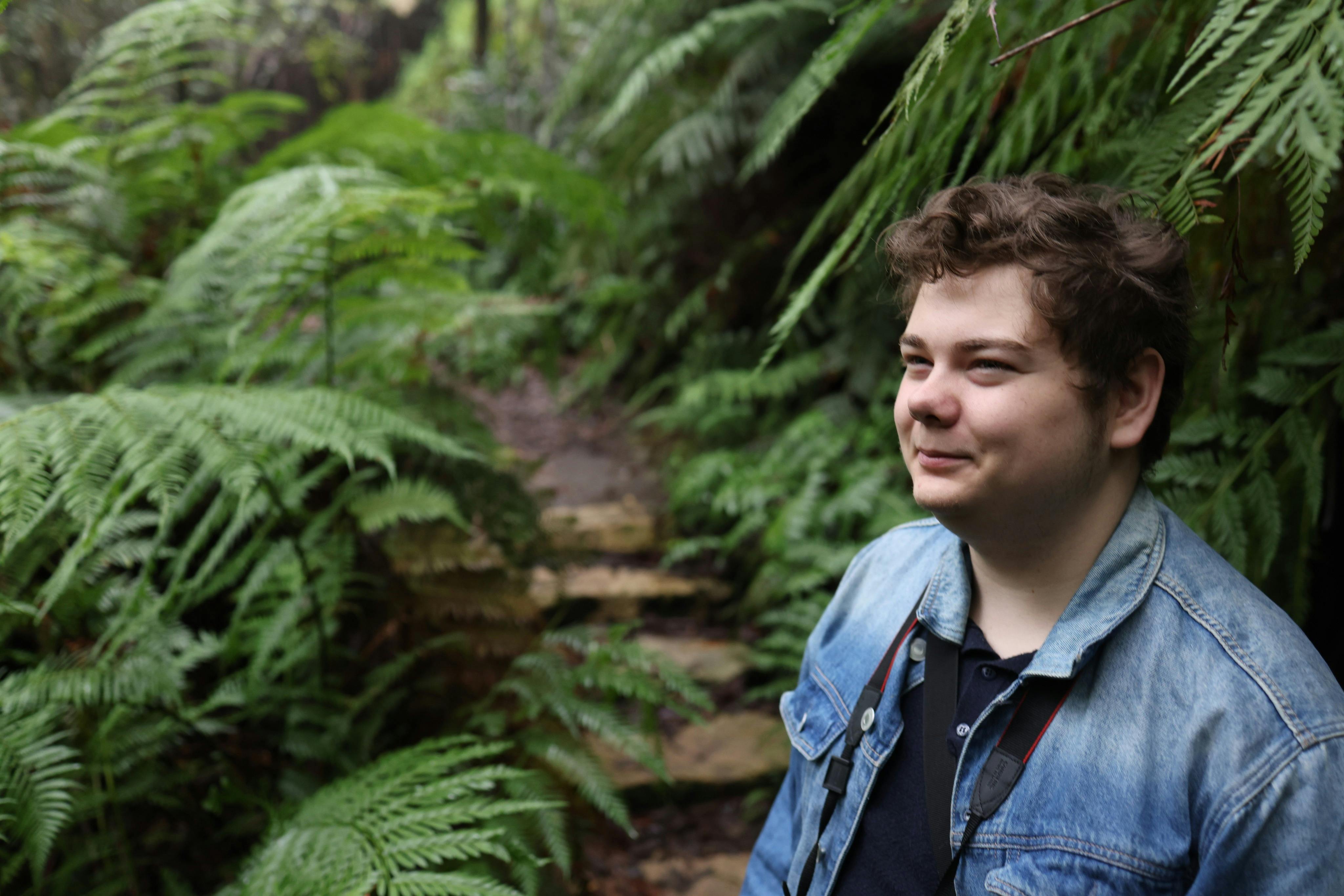Young man in with fern back drop in Blue Mountains