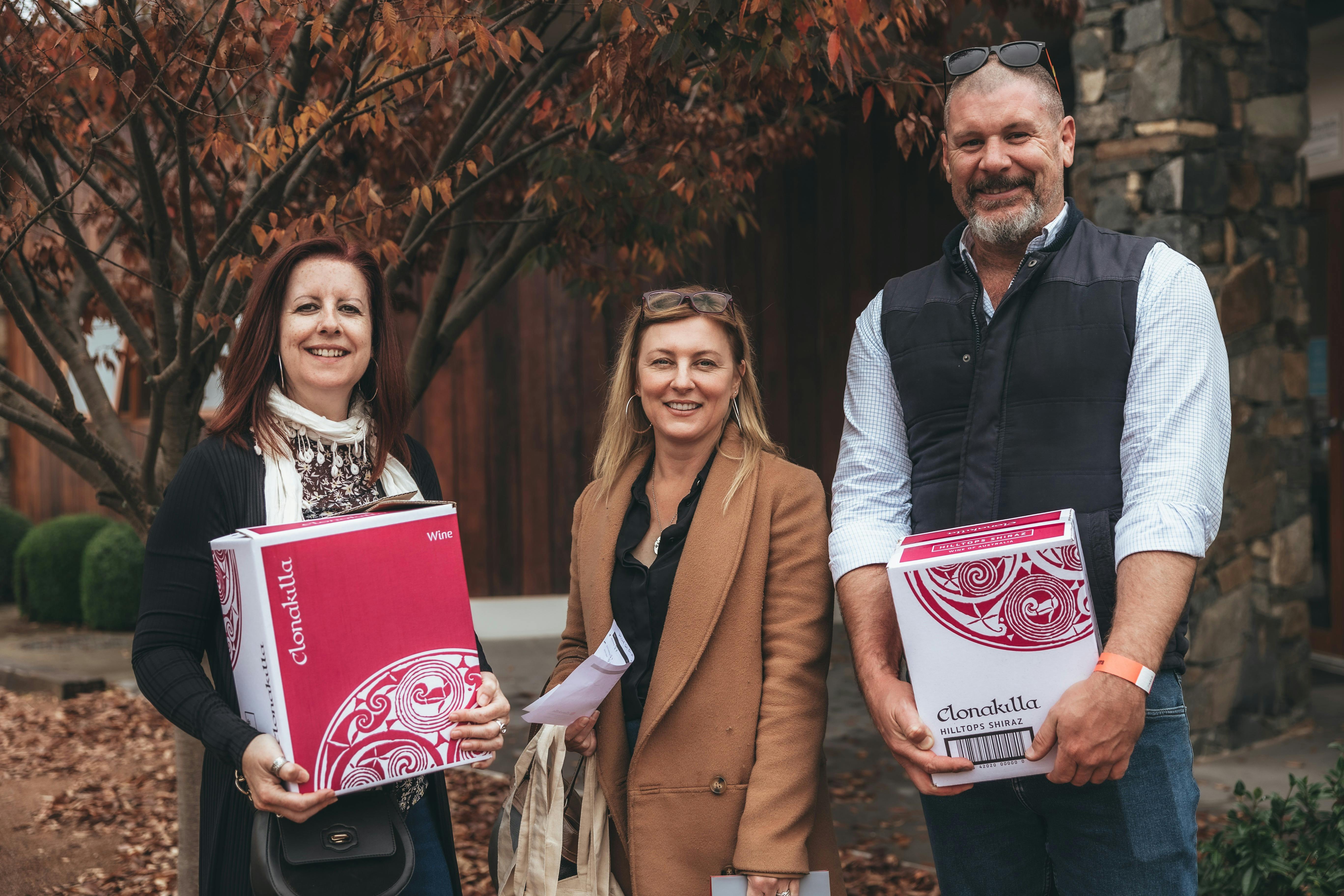 People holding boxes of wine at Clonakilla