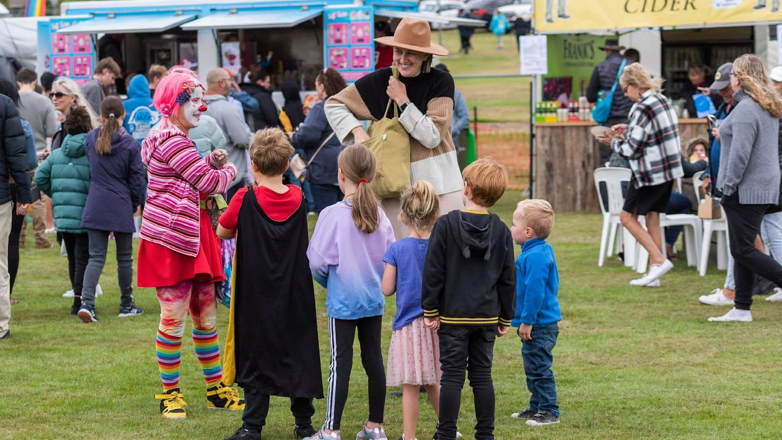 A clown entertaining the children.