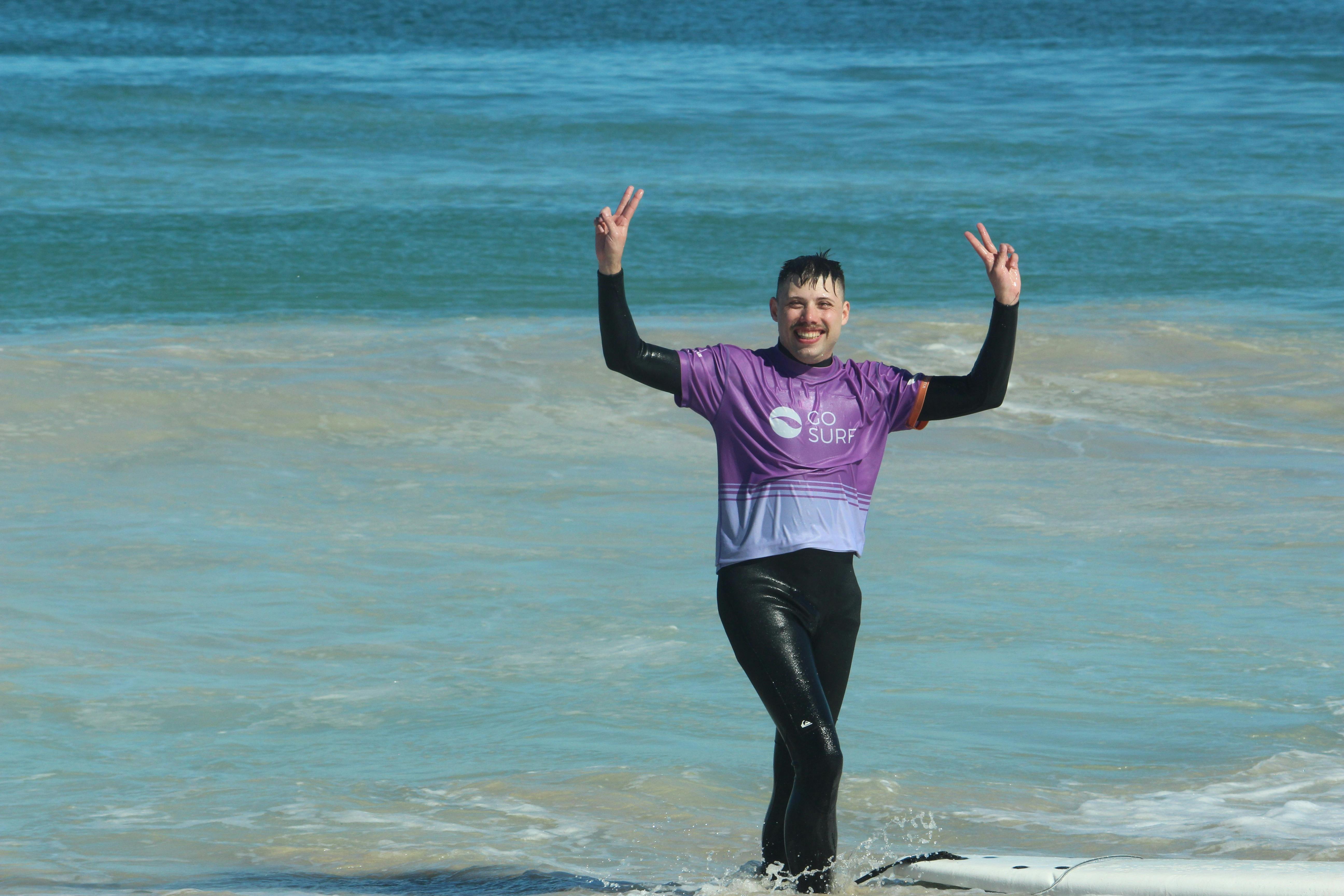 Pure stoke! 🌟 Riding the wave of excitement as this surfer conquers the surf with a beaming smile