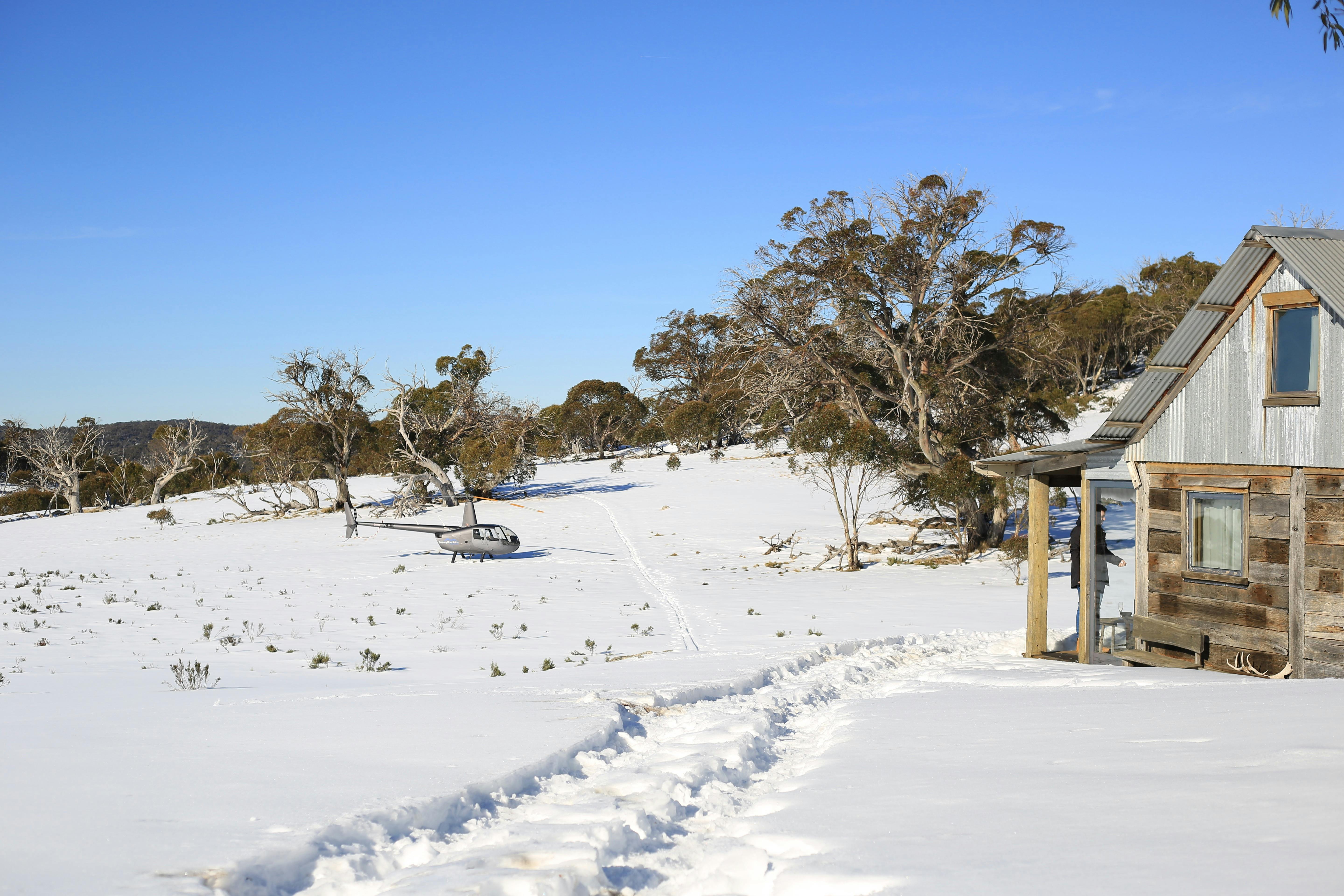 Robinson R44 landed on snow at private hut for Wilderness Picnic